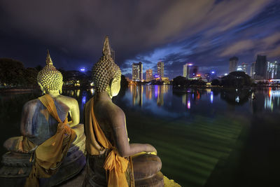 Panoramic view of illuminated buildings against sky at night