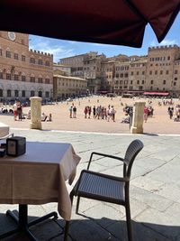 Empty chairs and tables at outdoor cafe