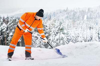 Rear view of man with snow on mountain