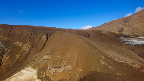 Scenic view of desert against clear blue sky