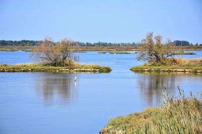 Scenic view of lake against clear blue sky