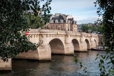 The famous pont neuf and the river seine in paris on a beautiful blue summer sky