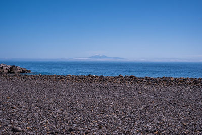 Scenic view of sea against clear blue sky