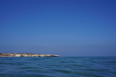 Scenic view of sea against clear blue sky