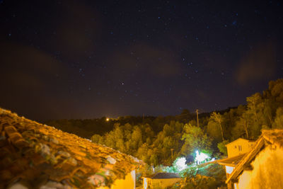 Scenic view of illuminated mountain against sky at night