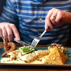 Cropped image of person holding food on table