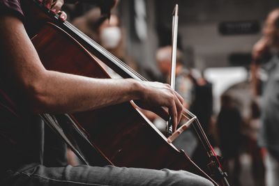 Cropped image of man playing guitar