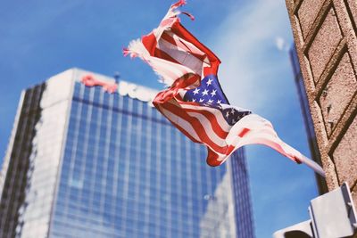 Low angle view of flag against blue sky