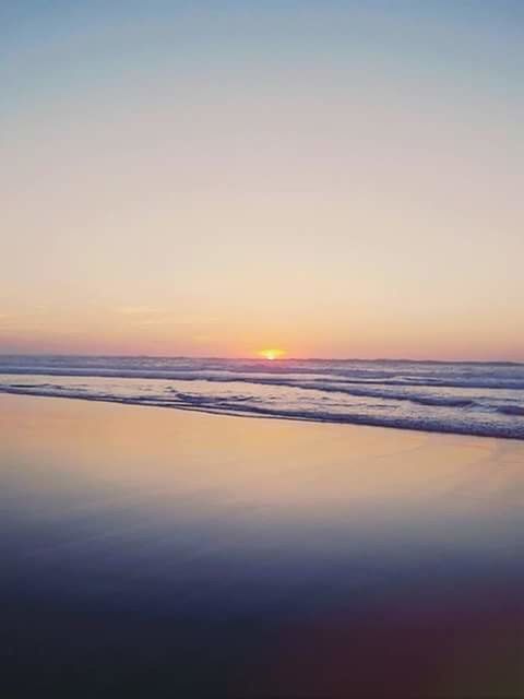 SCENIC VIEW OF SEA AGAINST SKY AT SUNSET