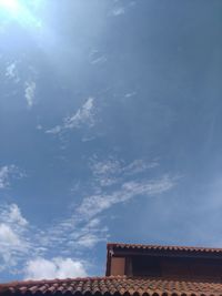 Low angle view of building against cloudy sky