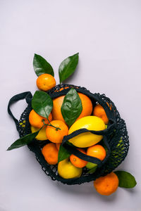 Healthy food and zero waste concept. set of citrus in mesh textile bag.