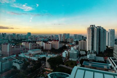 High angle view of modern buildings against sky during sunset