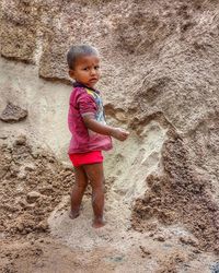 Full length of cute baby girl on sand