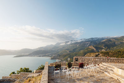 Scenic view of sea and mountains against sky