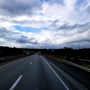 View of highway against cloudy sky