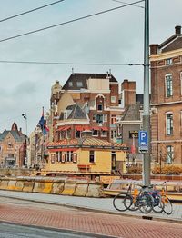 Bicycle in city against sky