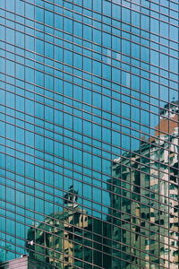 Full frame shot of glass building against sky