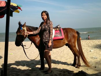 Full length of woman with horse