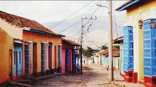 Dirt road amidst houses