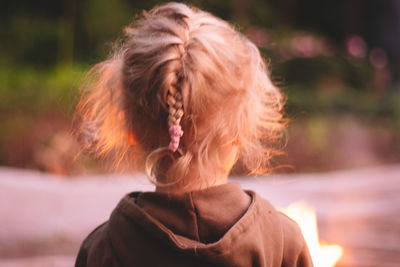 Rear view of woman standing outdoors