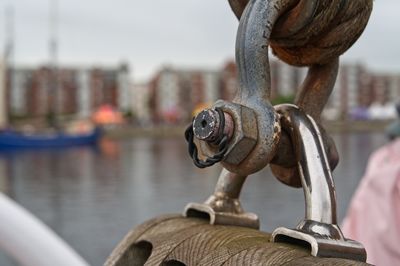 Close-up of rusty chain on boat in city