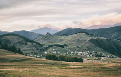 Scenic view of valley and mountains against sky