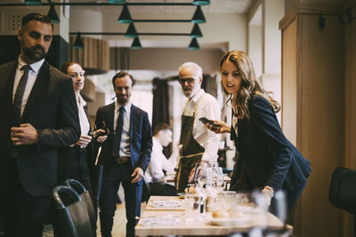 Business professionals arriving in restaurant