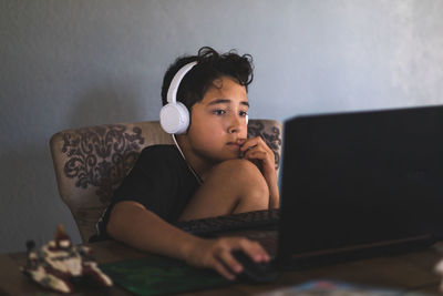 Boy doing his homework on laptop