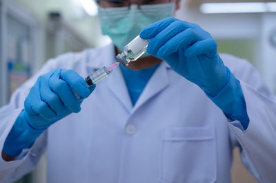 Midsection of person holding umbrella