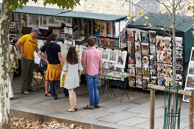 People standing at market stall in city