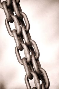 Close-up of metal chain against white background