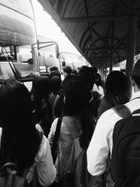 Rear view of people standing on train