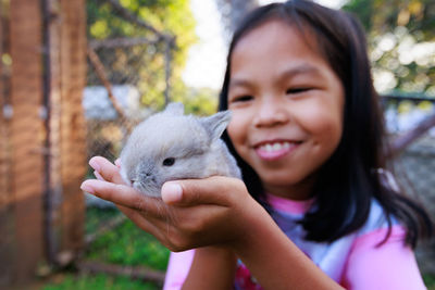 Close-up of woman holding rabbit