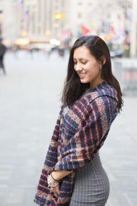 Portrait of young woman standing outdoors