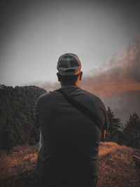 Rear view of man standing on mountain