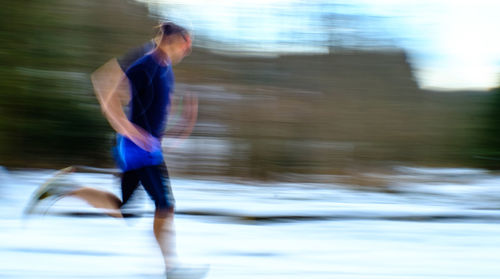 Side view of man running in city