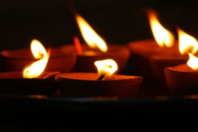 Close-up of illuminated candles on table