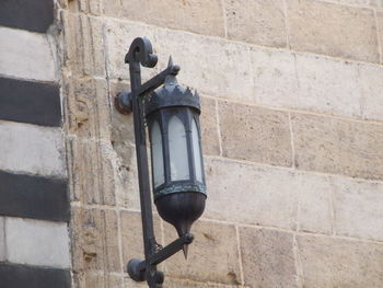 Low angle view of street light against wall