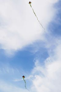 Low angle view of person paragliding against sky