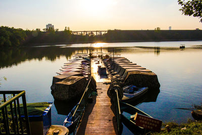 View of boats in lake at sunset