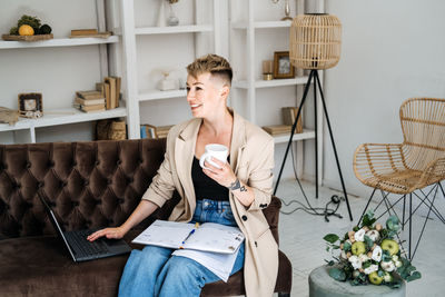 Modern hipster businesswoman with laptop and diary working at home office, planning, scheduling.