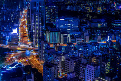 High angle view of illuminated buildings in city at night