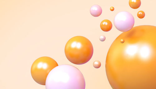 Low angle view of balloons against white background