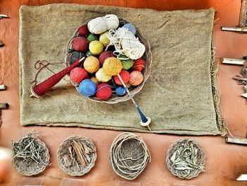 High angle view of colorful wools in wicker basket on table