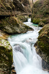 Scenic view of flowing river amidst rock formations