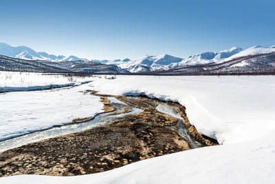 Scenic view of mountains against clear blue sky