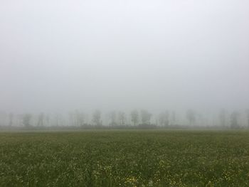 Scenic view of field against cloudy sky