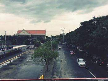 Traffic on road in city against sky