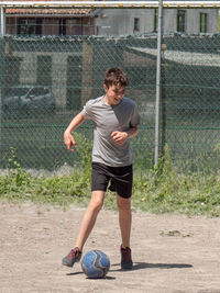 Full length of a boy playing soccer ball