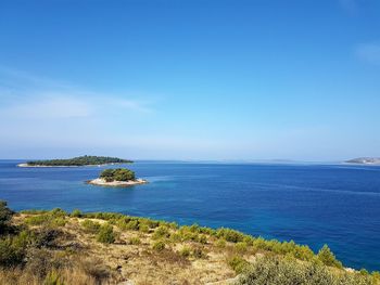 Scenic view of sea against clear blue sky